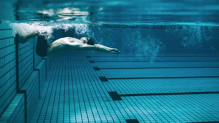 Man doing a flip turn in a pool