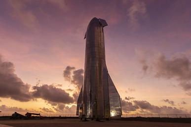 Photo of Elon Musk's Starship. Photo Source: https://en.wikipedia.org/wiki/SpaceX_Starship#/media/File:Starship_Mk1.jpg