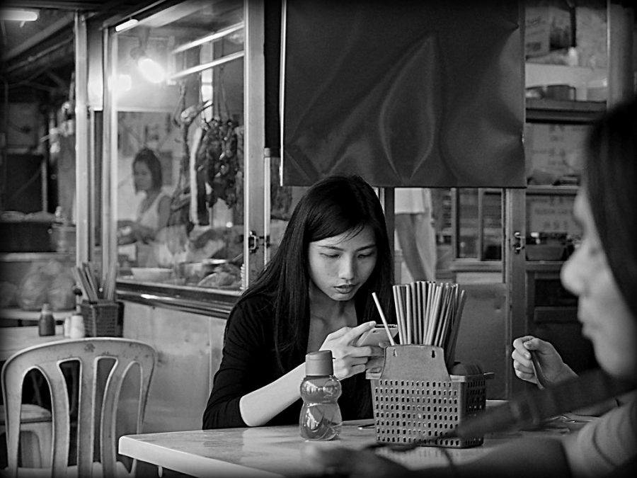 Phone addiction | KL Street OM D E-M1 by Johnragai-Moment Catcher is licensed under CC BY 2.0