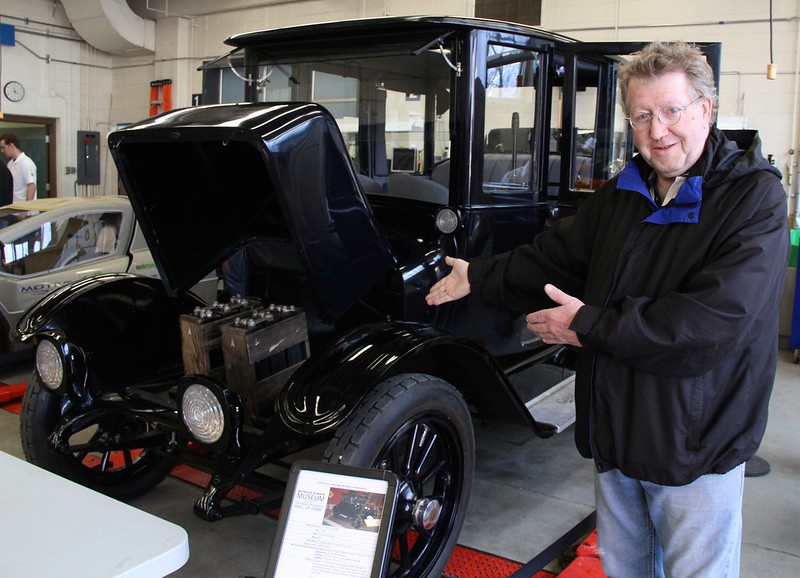 "Alf White admiring a very old electric car at the Future of Transportation Solar Energy Society event at NAIT" by Green Energy Futures is licensed under CC BY-NC-SA 2.0