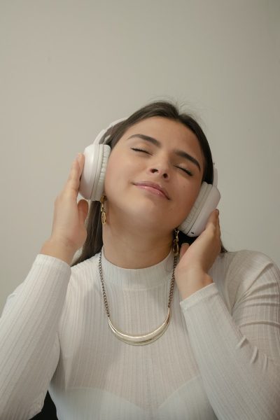 a woman with her eyes closed holding a phone to her ear