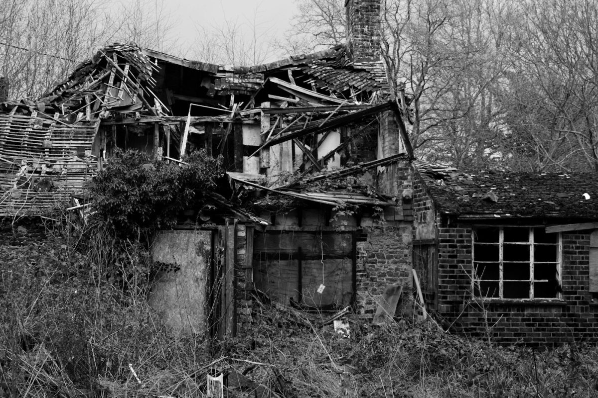 grayscale photo of wrecked house