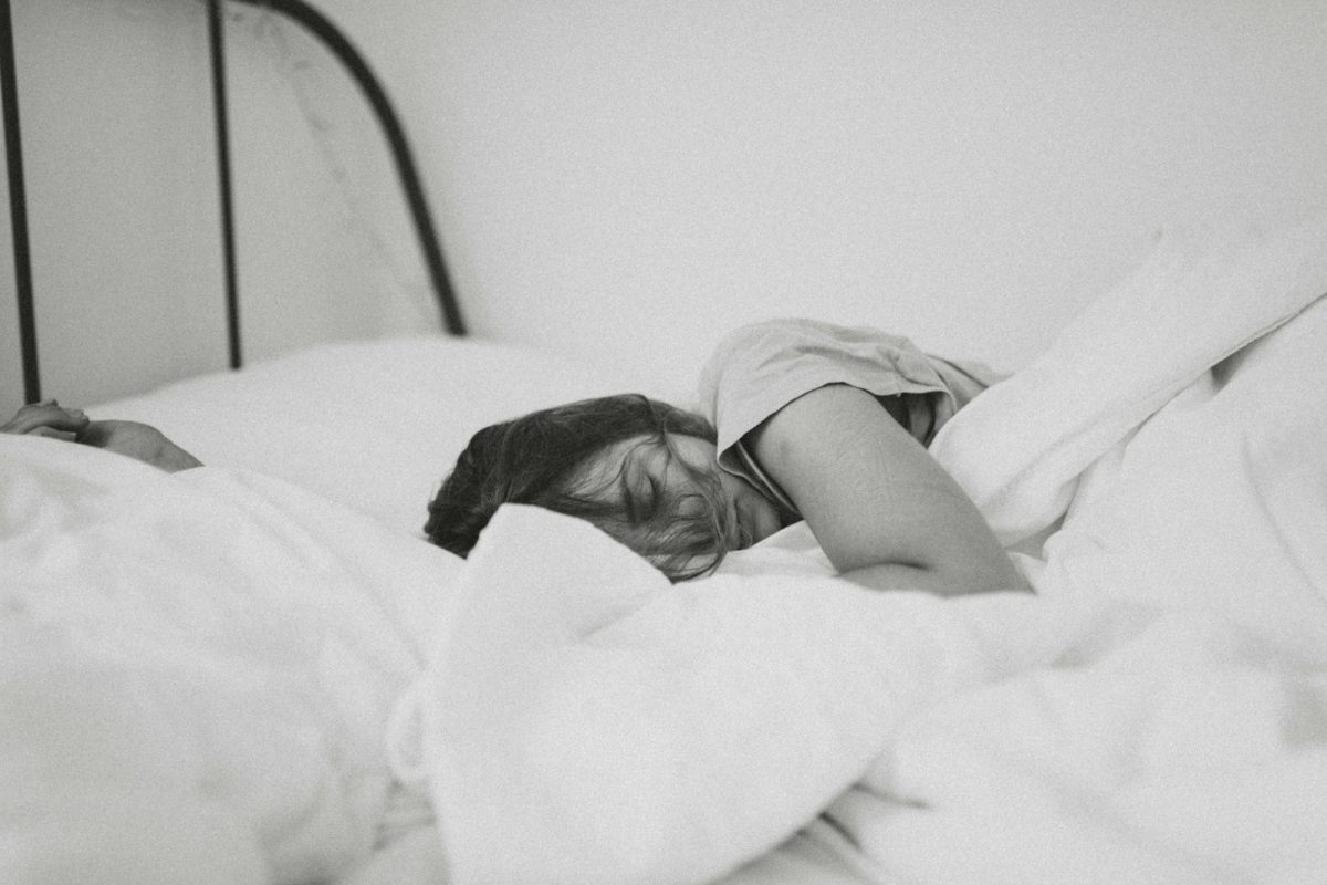 grayscale+photo+of+sleeping+woman+lying+on+bed