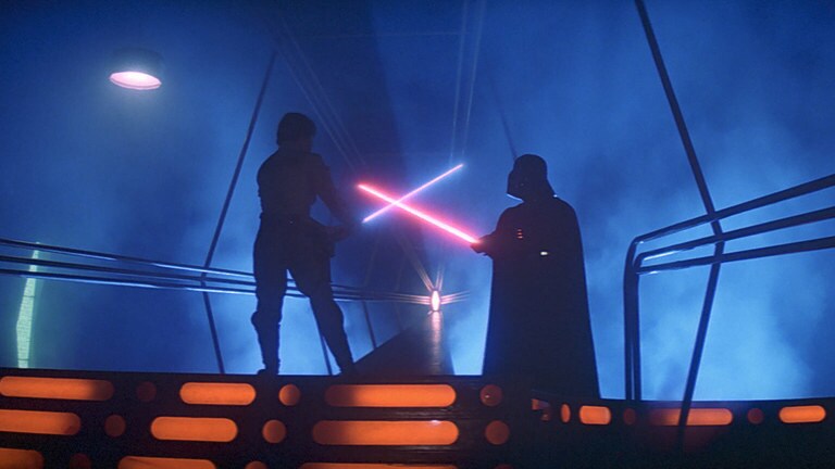 Luke Skywalker and Darth Vader draw their lightsabers, ready to duel in the carbon-freezing chamber at Cloud City, Bespin.